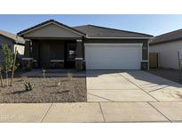 Charming single-story home featuring a two-car garage and low maintenance landscaping at 13179 E Verbina Ln, Florence, AZ 85132