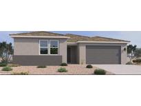 Charming single-story home with a two-car garage and low-maintenance desert landscaping at 15734 W Brown St, Waddell, AZ 85355