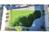 Aerial view of a backyard featuring an artificial turf lawn, paver patio, and desert landscaping at 20217 W Desert Bloom St, Buckeye, AZ 85326