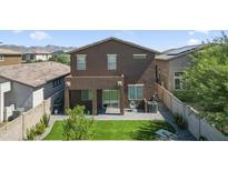 View of backyard showing pavers, small grass area, and privacy fence at 20217 W Desert Bloom St, Buckeye, AZ 85326