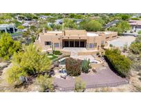 Aerial view of private backyard pool, putting green, and patio, blending leisure with elegant southwestern design at 22050 N 90Th St, Scottsdale, AZ 85255