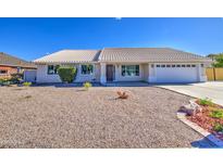 Single-story home with a tile roof and desert landscaping on a sunny day at 2317 E Lynwood St, Mesa, AZ 85213
