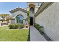 Welcoming home entrance featuring manicured landscaping and a well-lit pathway to the front door at 3202 E Orange Dr, Phoenix, AZ 85018