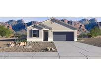 New construction home with a well-manicured xeriscaped front yard, 2-car garage and mountain backdrop at 35556 N Common Ct, San Tan Valley, AZ 85140