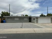 Charming single-story home with a well-kept gravel front yard and attached two-car garage at 3608 W Hazelwood St, Phoenix, AZ 85019