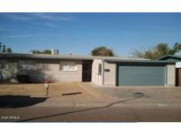 Charming single-story home featuring a well-maintained lawn and a neatly attached garage at 3608 W Hazelwood St, Phoenix, AZ 85019