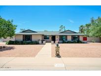 Charming single-story home with a manicured yard and walkway leading to the front door at 4079 E Shangri La Rd, Phoenix, AZ 85028