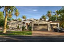 Beautiful stone accented exterior with a three car garage, desert landscaping, and modern design at 4419 N 46Th Pl, Phoenix, AZ 85018
