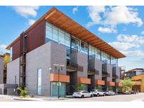Contemporary condo building with a wood overhang, concrete construction, large windows and a stylish facade at 4747 N Scottsdale Rd # 4003, Scottsdale, AZ 85251