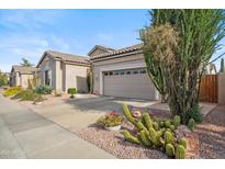 Charming single-story home with desert landscaping, a two-car garage and a tiled roof at 4819 E Villa Theresa Dr, Scottsdale, AZ 85254