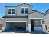 Two story home featuring an attached garage and neutral-colored stucco at 5053 E Umber Rd, San Tan Valley, AZ 85143