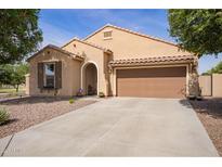 Charming single-story home featuring a tile roof, a two-car garage and low maintenance desert landscaping at 6482 S Claiborne Ave, Gilbert, AZ 85298