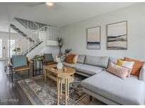 Cozy living room with modern decor, staircase, and plush sectional sofa at 6945 E Osborn Rd # E, Scottsdale, AZ 85251