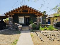Charming craftsman-style home featuring river rock pillars and exposed beam porch at 723 E Moreland St, Phoenix, AZ 85006