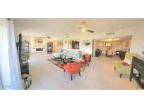 Bright living room featuring a ceiling fan, modern furniture, and access to other rooms of the house at 7860 E Camelback Rd # 404, Scottsdale, AZ 85251