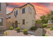 Inviting two-story home with desert landscaping and charming architectural details at 8313 E Impala Ave, Mesa, AZ 85209