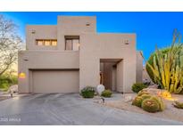 Contemporary home boasting desert landscaping, and a neutral color palette complements the Arizona landscape at 10772 E Running Deer Trl, Scottsdale, AZ 85262