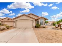 Charming single-story home featuring a two-car garage, desert landscaping, and a tile roof at 13137 W Wilshire Dr, Goodyear, AZ 85395
