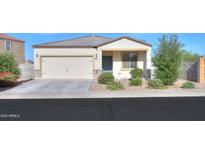 Charming single-story home featuring a two-car garage and well-maintained landscaping at 19365 N Pietra Dr, Maricopa, AZ 85138
