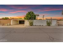 Charming single-story home with unique desert landscaping, white fencing and a sunset sky at 2018 E Balboa Dr, Tempe, AZ 85282