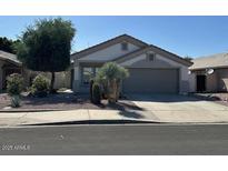 Charming single-story home featuring desert landscaping and a two-car garage at 21192 N 80Th Ln, Peoria, AZ 85382
