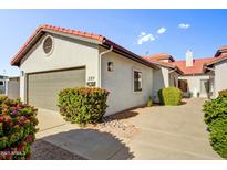 Charming single-story home showcasing a well-maintained yard, red tile roof and stucco facade at 225 S Pioneer -- # 36, Mesa, AZ 85204