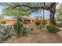 Charming single-story home with desert landscaping, mature trees, and a red tile roof at 23240 N Country Club Trl, Scottsdale, AZ 85255