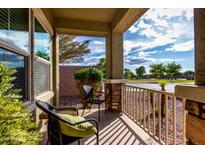 Cozy front porch features stone pillars, neutral paint, and relaxing seating area overlooking the street at 2597 E Hickory St, Gilbert, AZ 85298