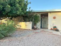 Charming home exterior with desert landscaping, walkway, and privacy wall in a quiet residential neighborhood at 3231 N 81St Pl, Scottsdale, AZ 85251