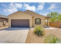 Charming single-story home with a well-maintained front yard and a two-car garage at 33731 N Bowles Dr, San Tan Valley, AZ 85144