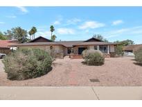 Charming single-story home featuring a desert-landscaped front yard and red brick accents at 350 E Huber St, Mesa, AZ 85201