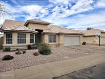 Charming single-story home with tile roof, desert landscaping, and a spacious two car garage at 3580 W Dublin St, Chandler, AZ 85226