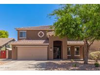 Charming two-story home with a two-car garage, arched entryway, and desert landscaping at 45539 W Long Way, Maricopa, AZ 85139