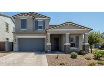 Charming two-story home with a well-manicured front yard and a gray exterior paint at 5109 E Helena Dr, Scottsdale, AZ 85254