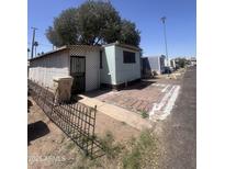 Single-story mobile home featuring brick trim and desert landscaping at 6439 W Myrtle Ave # 49, Glendale, AZ 85301