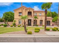 Charming two-story home with a red tile roof, stone accents and a manicured lawn at 7236 W Electra Ln, Peoria, AZ 85383