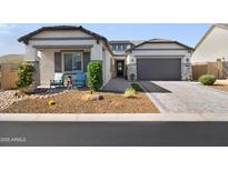 Charming single-story home boasts a desert landscape, stone accents, and a spacious two-car garage at 8040 E Jaeger St, Mesa, AZ 85207