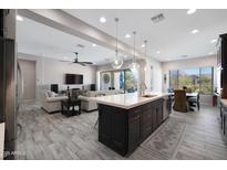 Spacious open-concept living space with a seamless flow between the kitchen and living room at 8040 E Jaeger St, Mesa, AZ 85207