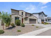 Charming two-story home featuring a two-car garage and low-maintenance landscaping at 9230 E Scott Ave, Mesa, AZ 85212