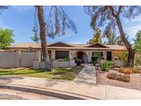 Charming townhome featuring lovely landscaping and a welcoming walkway to the front entrance at 1047 W Laguna Dr, Tempe, AZ 85282