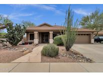 Charming single-story home featuring desert landscaping, a covered porch, and a two-car garage at 11101 W Wilshire Dr, Avondale, AZ 85392