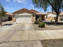 Charming single-story home featuring a two-car garage and a well-maintained front yard at 15162 W Monroe St, Goodyear, AZ 85338