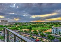 View of lush golf course from balcony with beautiful sunset views, manicured grounds, and green fairways at 15215 N Kierland Blvd # 636, Scottsdale, AZ 85254