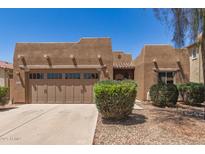 Charming single-story home featuring a well-manicured front yard and a two-car garage at 15674 W Mackenzie Dr, Goodyear, AZ 85395
