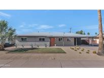 Charming single-story home with brickwork, desert landscaping, and a vibrant orange door at 1617 W Lamar Rd, Phoenix, AZ 85015