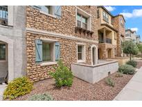 Stunning stone exterior, light blue shutters, and beautiful landscaping add to the charm of this residence at 1727 E Chelsea Ln, Gilbert, AZ 85295