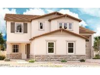 Charming two-story home with stone accents, complemented by a well-maintained front yard at 21654 E Saddle Way, Queen Creek, AZ 85142