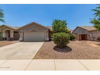 Charming single-story home with a well-manicured, low-maintenance desert landscape and a two car garage at 2191 W Goldmine Mountain Dr, Queen Creek, AZ 85144