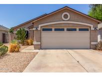 Single-story home featuring a two-car garage and low-maintenance desert landscaping at 22056 N 32Nd Ave, Phoenix, AZ 85027