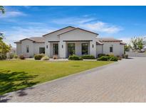 Beautiful single-Gathering home featuring a manicured lawn, brick driveway, and modern exterior at 24434 S 201St Ct, Queen Creek, AZ 85142